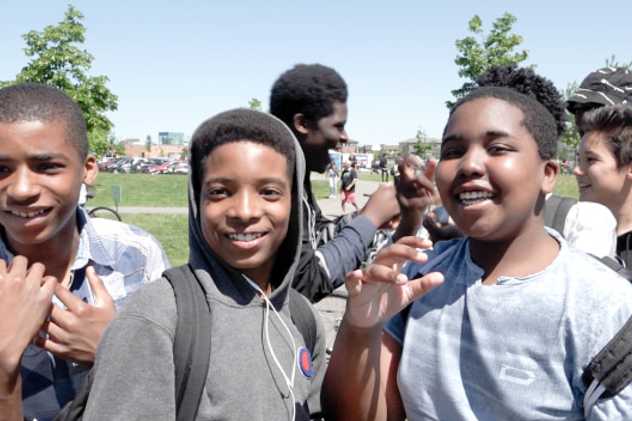 Three young teens smiling at a Big Give event.